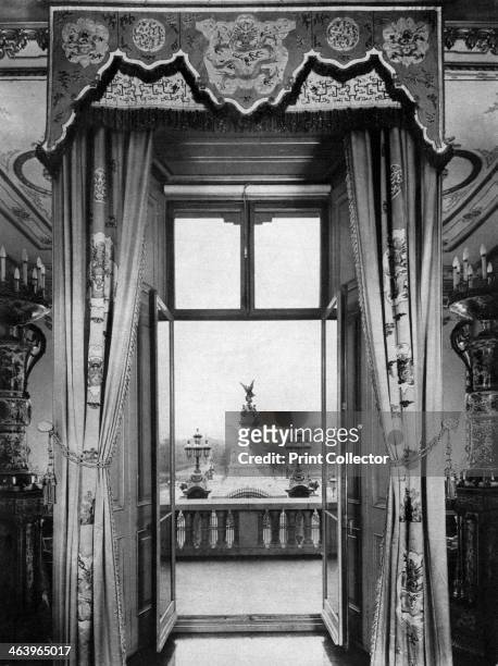 View of the Victoria Monument from inside Buckingham Palace, London, 1935. The Victoria Monument stands at the end of the Mall in front of Buckingham...