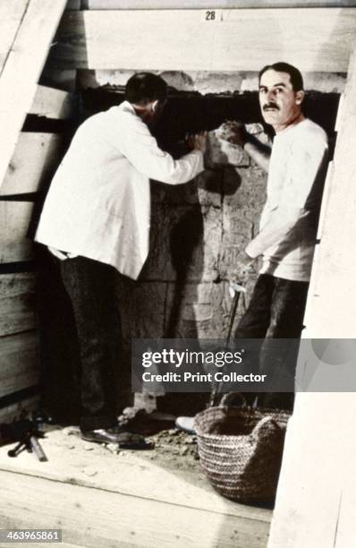 Howard Carter and a colleague excavating a tomb in the Valley of the Kings, Egypt, 1922. Carter famously discovered the intact tomb of the Pharaoh...