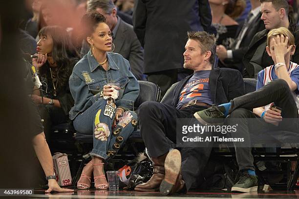 All Star Game: Celebrity singer Rihanna with actor Ethan Hawke sitting courtside during Team East vs Team West game at Madison Square Garden. New...