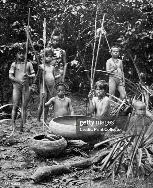 Indians of the Putumayo River with a decapitated head, Amazonia. Possibly members of the Shuar people, who practised headhunting. A print from...