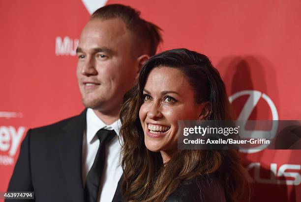 Recording artists Mario Treadway and Alanis Morissette arrive at the 2015 MusiCares Person of The Year honoring Bob Dylan at Los Angeles Convention...