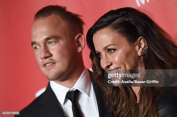 Recording artists Mario Treadway and Alanis Morissette arrive at the 2015 MusiCares Person of The Year honoring Bob Dylan at Los Angeles Convention...