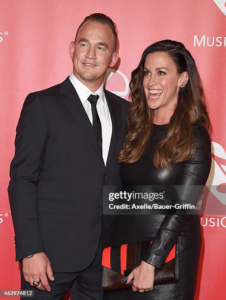 Recording artists Mario Treadway and Alanis Morissette arrive at the 2015 MusiCares Person of The Year honoring Bob Dylan at Los Angeles Convention...