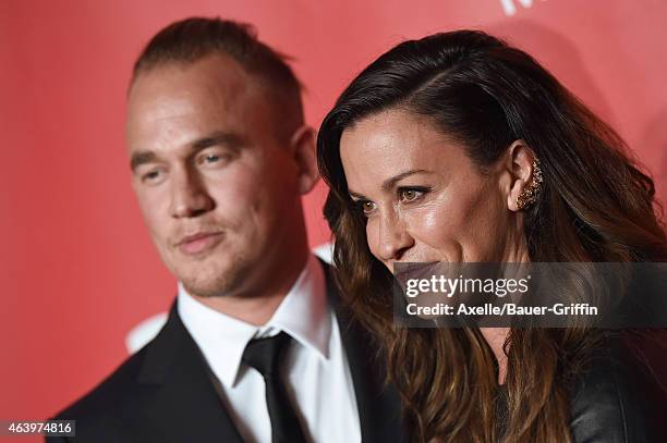 Recording artists Mario Treadway and Alanis Morissette arrive at the 2015 MusiCares Person of The Year honoring Bob Dylan at Los Angeles Convention...