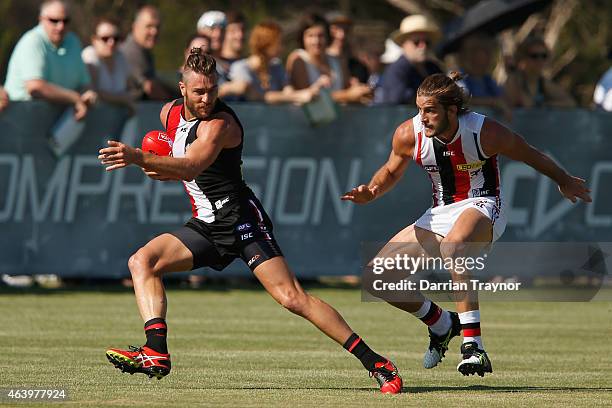 Sam Fisher evades Josh Bruce of the Saints during the St Kilda Saints AFL intra club match at Linen House Oval on February 21, 2015 in Melbourne,...