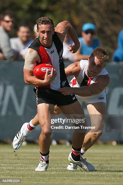 Luke Dunstan evades Sebastian Ross during the St Kilda Saints AFL intra club match at Linen House Oval on February 21, 2015 in Melbourne, Australia.