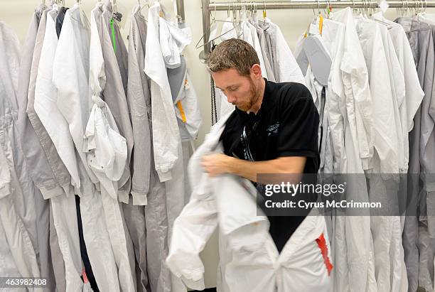 Justin Bergfalk space craft technician climbs out of clean suite after working on the weather satellite, GOES-R at Lockheed Martin Space Systems on...