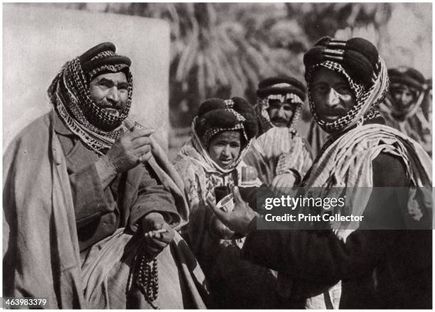 Sheikh enjoying the famous Arab coffee', Iraq, 1925. A print from Baghdad, Camera Studio Iraq, published by Hasso Bros, Rotophot AG, Berlin, 1925.