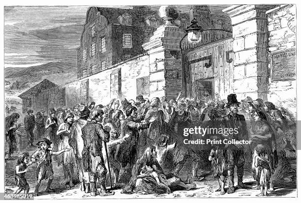 The Irish Famine, 1845-1849, . Starving peasants at a workhouse gate. Illustration from The life and times of Queen Victoria by Robert Wilson, .
