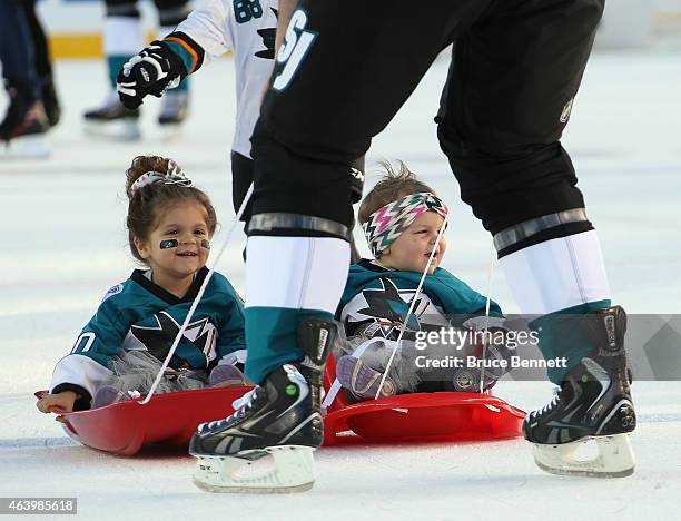 John Scott of the San Jose Sharks pulls his children around the ice during the family skate at Levi's Stadium on February 20, 2015 in Santa Clara,...