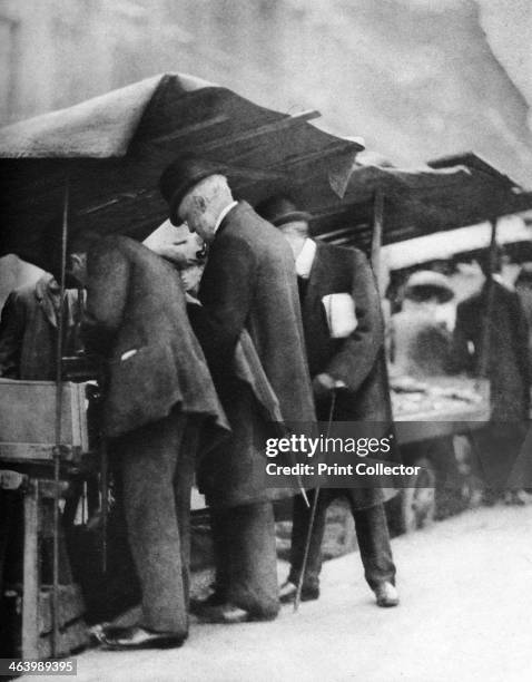 Bookstalls of the Farringdon Road market, London, 1926-1927. From Wonderful London, volume II, edited by Arthur St John Adcock, published by...