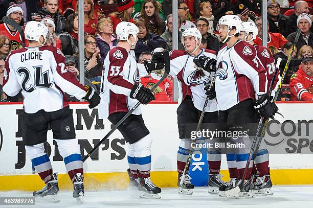 Tyson Barrie of the Colorado Avalanche celebrates with teammates, including Cody McLeod and Nate Guenin, after scoring in the first period against...