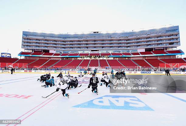 The San Jose Sharks stretch at center ice during practice one day prior to the 2015 Coors Light Stadium Series game between the Los Angeles Kings and...