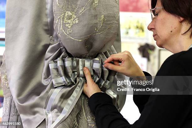 Tailor works on a dress by costume designer Gabriella Pescucci for the TV Series 'Penny Dreadful' at the Tirelli Atelier on February 20, 2015 in...