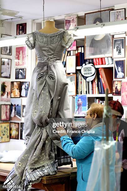 Tailors work on a dress by costume designer Gabriella Pescucci for the TV Series 'Penny Dreadful' at the Tirelli Atelier on February 20, 2015 in...