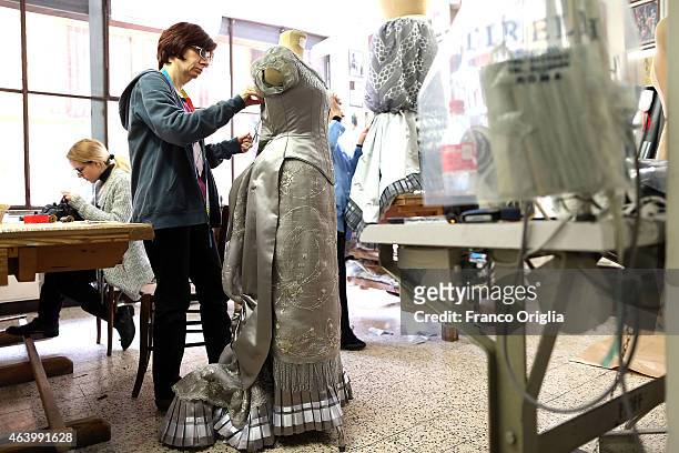 Tailors work on a dress by costume designer Gabriella Pescucci for the TV Series 'Penny Dreadful' at the Tirelli Atelier on February 20, 2015 in...