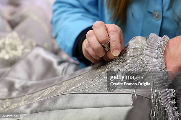 Tailor works on a dress by costume designer Gabriella Pescucci for the TV Series 'Penny Dreadful' at the Tirelli Atelier on February 20, 2015 in...