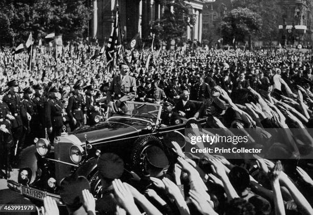 Adolf Hitler departing after making a speech, Berlin, Germany, 1 May 1934. A print from Adolf Hitler. Hitler receiving the acclaim of the crowd....