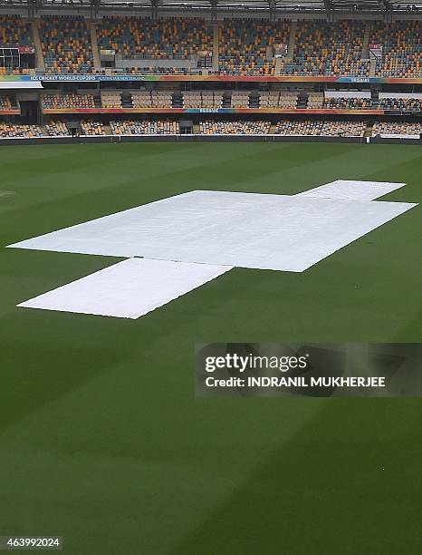 General view of the covered pitch amidst rain from Tropical Cyclone Marcia ahead of the 2015 Cricket World Cup match between Australia and Bangladesh...