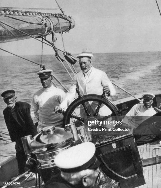 King George V at the helm of his yacht Britannia, c1930s. Illustration from George V and Edward VIII, A Royal Souvenir, by FGH Salusbury, a souvenir...