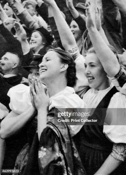 Admiring crowd saluting German Nazi leader Adolf Hitler, 1938. A print from Wie die Oftmark ihre Befreiung erlebte , Berlin, 1940.