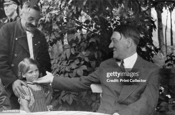 'Here, my Führer, is my grandchild', 1936. A man intoduces his young granddaughter to German Nazi leader Adolf Hitler . A print from Adolf Hitler....