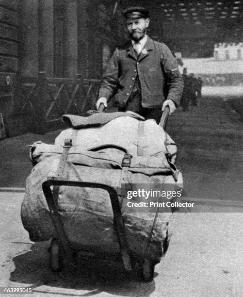 Train porter, London, 1926-1927. From Wonderful London, volume II, edited by Arthur St John Adcock, published by Amalgamated Press .