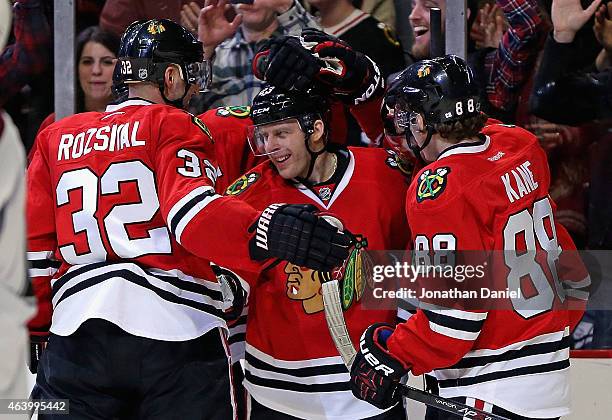 Kris Versteeg of the Chicago Blackhawks celebrates his second period goal with Michal Rozsival and Patrick Kane against the Colorado Avalanche at the...