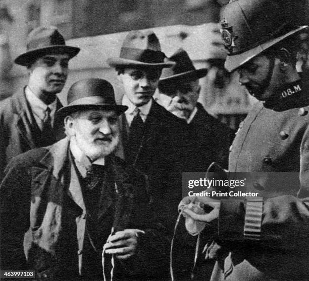 Distribution of the Maundy Money, Thursday before Easter, Tower of London, 1926-1927. A policeman carries out an ancient custom. Illustration from...