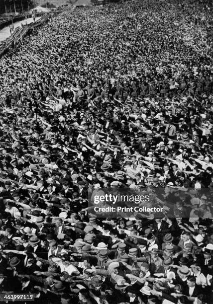 Nazi rally, Ehrenbreitstein, Germany, August 1934. A large crowd gives the Nazi salute. A print from Adolf Hitler. Bilder aus dem Leben des Führers,...