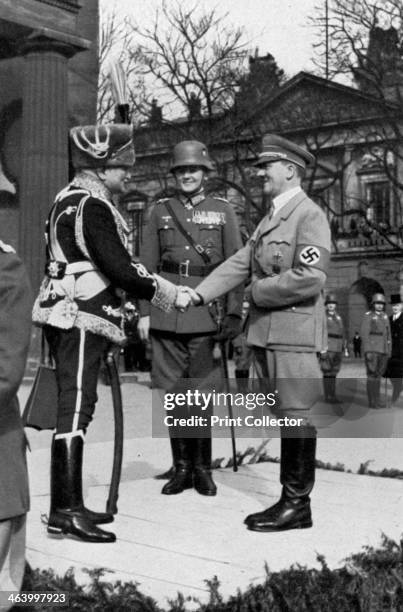 Adolf Hitler during Memorial Day at the war memorial, Berlin, Germany, 1935. Hitler shaking hands with a veteran in cavalry uniform. A print from...