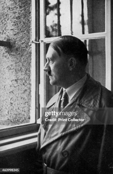 Adolf Hitler looks out of his cell window at Landsberg Fortress, Bavaria, Germany, 1934. Hitler visiting the prison where he spent 8 months in 1924...