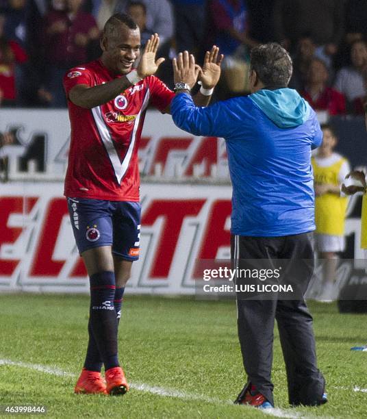 Leiton Jimenez of Veracruz celebrates his goal against Toluca with coach Carlos Reinoso during their Mexican Clausura tournament football match at...