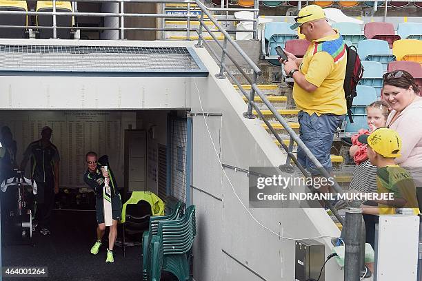 Australian supporters watch from the stands as cricketer Brad Haddin does shadow batting indoors amidst rain from Cyclone Marcia ahead of the 2015...