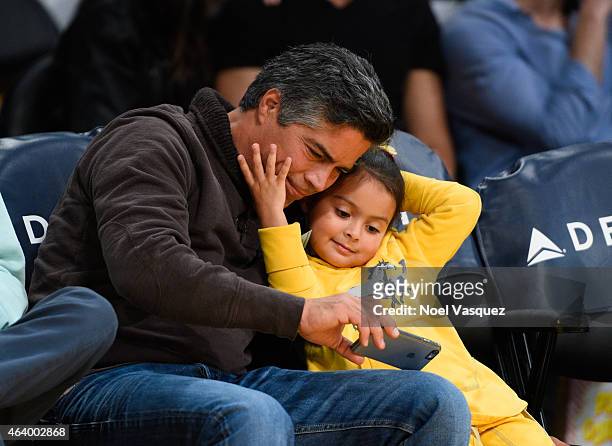 Esai Morales and his daughter Mariana Oliveira Morales attend a basketball game between the Brooklyn Nets and the Los Angeles Lakers at Staples...