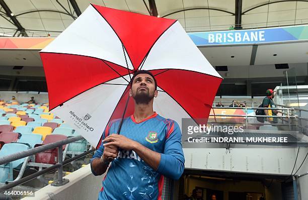 Bangladesh captain Mashrafe Mortaza looks skywards from the players' entrance to the ground as rain from Cyclone Marcia delays the start of the 2015...