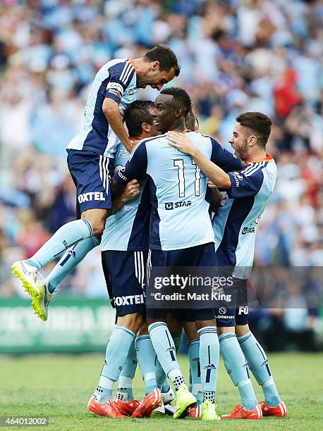 Rhyan Grant of Sydney FC celebrates with team mates after scoring a goal as Alex Brosque of Sydney FC jumps over the top during the round 18 A-League...