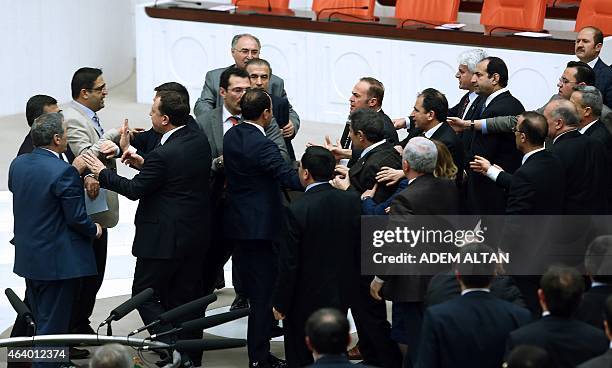 Ruling party and opposition Turkish lawmakers scuffle during a debate over a controversial bill to boost police powers against protesters at the...