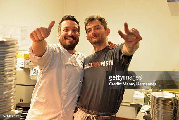 Fabio Viviani and Gabriele Corcos prepare food at the Tuscan Trio Dinner hosted by Fabio Viviani, Debi Mazar and Gabriele Corcos during the 2015 Food...