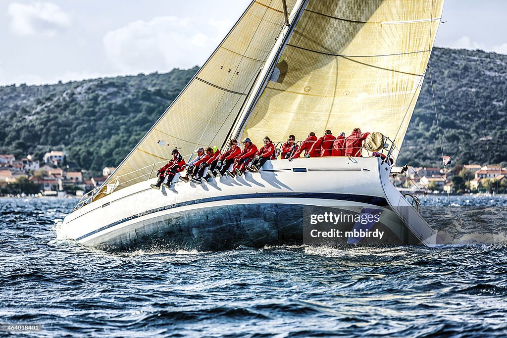 Sailing crew on sailboat during regatta