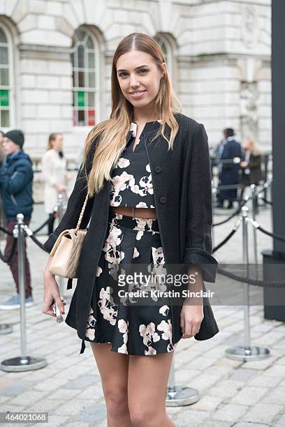 Model Amber Le Bon wears an Eudon Shoi two piece, Goat coat, Chanel bag on day 1 of London Collections: Women on February 20, 2015 in London, England.