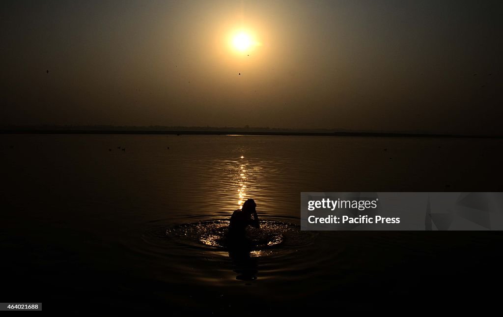 A devotee taking holydip in morning at Ganges...