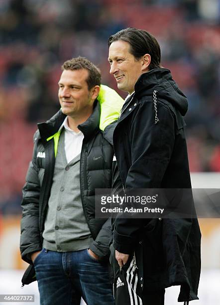 Markus Weinzierl Head Coach of FC Augsburg chats to Roger Schmidt Head Coach of Bayer Leverkusen before the Bundesliga match between FC Augsburg and...