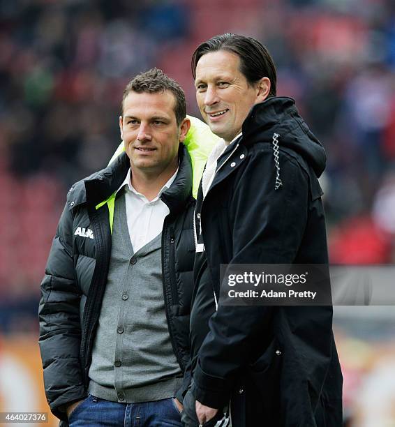 Markus Weinzierl Head Coach of FC Augsburg chats to Roger Schmidt Head Coach of Bayer Leverkusen before the Bundesliga match between FC Augsburg and...