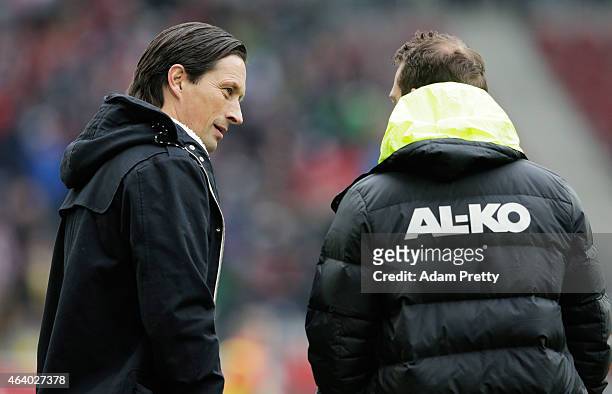 Markus Weinzierl Head Coach of FC Augsburg chats to Roger Schmidt Head Coach of Bayer Leverkusen before the Bundesliga match between FC Augsburg and...