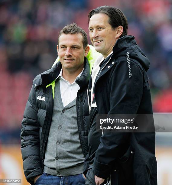 Markus Weinzierl Head Coach of FC Augsburg chats to Roger Schmidt Head Coach of Bayer Leverkusen before the Bundesliga match between FC Augsburg and...