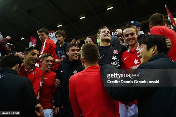 Mainz 05 players celebrate with fans after the Bundesliga match between 1. FSV Mainz 05 and Eintracht Frankfurt at Coface Arena on February 21, 2015...
