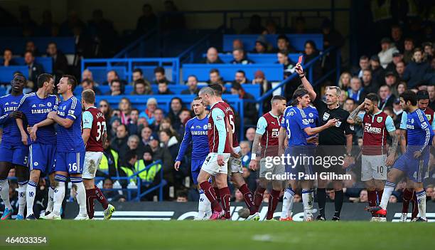 Referee Martin Atkinson shows the red card to Nemanja Matic of Chelsea during the Barclays Premier League match between Chelsea and Burnley at...