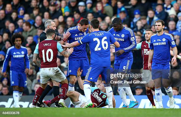 Referee Martin Atkinson shows the red card to Nemanja Matic of Chelsea for his reaction to the tackle by Ashley Barnes of Burnley during the Barclays...