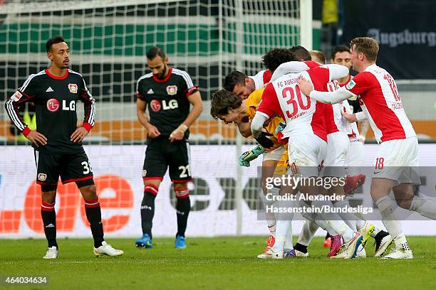 Marwin Hitz, keeper of Augsburg celebrates scoring the 2nd team goal with his team mates whilst Oemer Toprak of Leverkusen looks dejected with his...